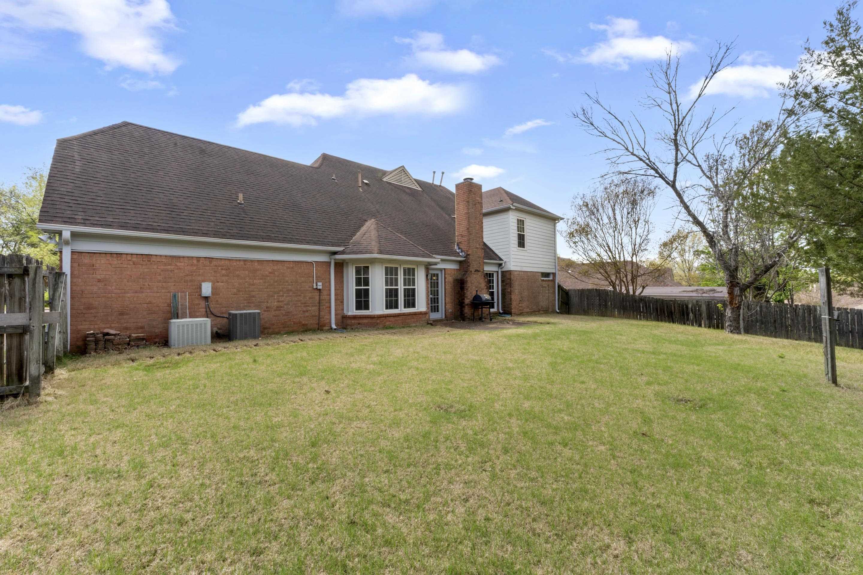 8956 Meadow Ridge Cove East Memphis, TN 38016 - Photo 27 of 28 a backyard of a house with lots of green space