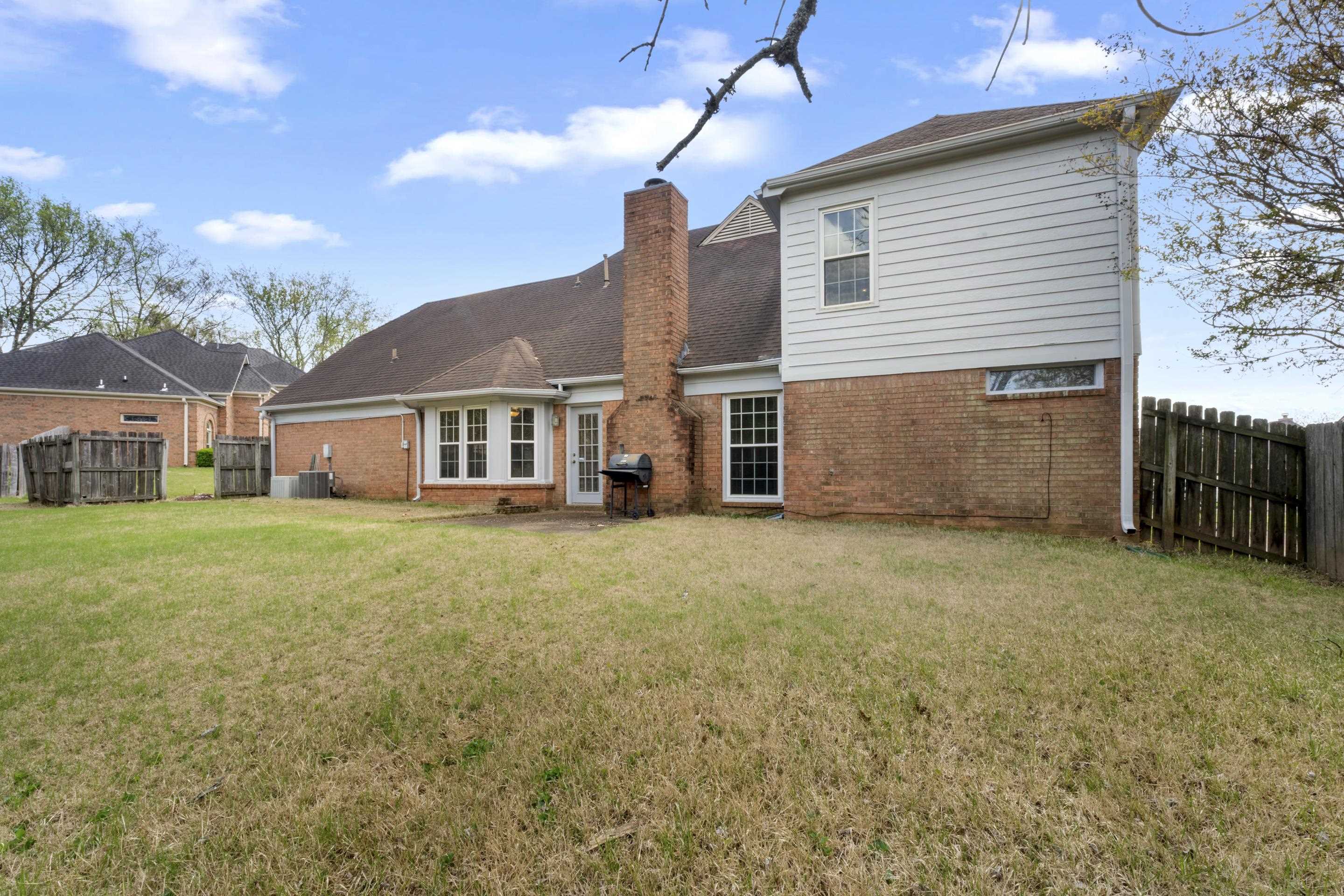 8956 Meadow Ridge Cove East Memphis, TN 38016 - Photo 28 of 28 a front view of a house with a garden