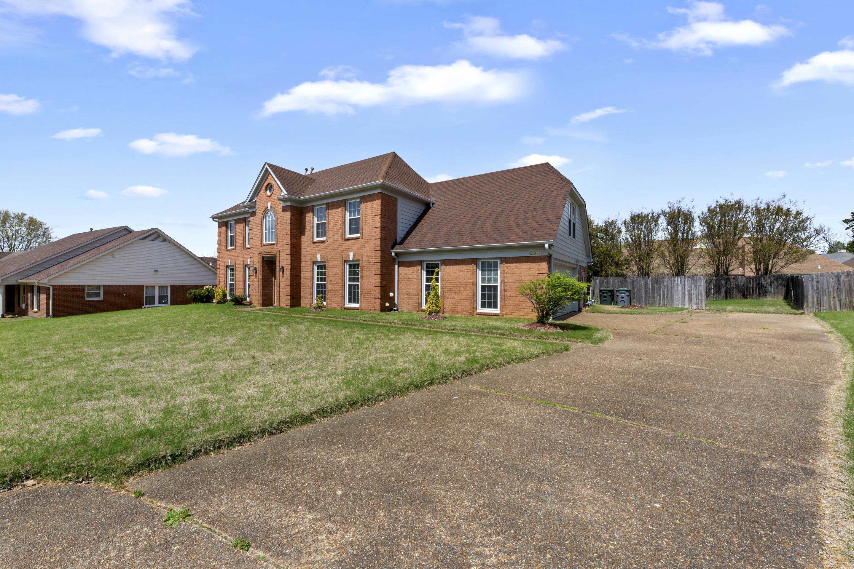 8956 Meadow Ridge Cove East Memphis, TN 38016 - Photo 3 of 28 a front view of a house with yard and green space