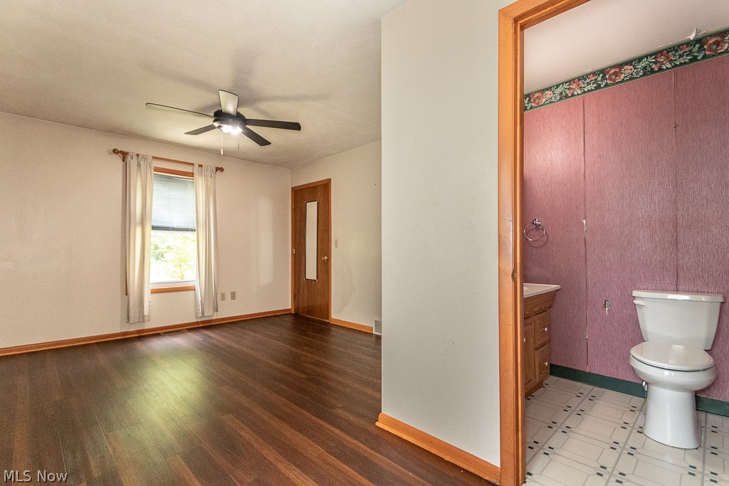 4517 Mackall Road Cleveland, OH 44121 - Photo 27 of 41 Bathroom with vanity, ceiling fan, wood-type flooring, and toilet
