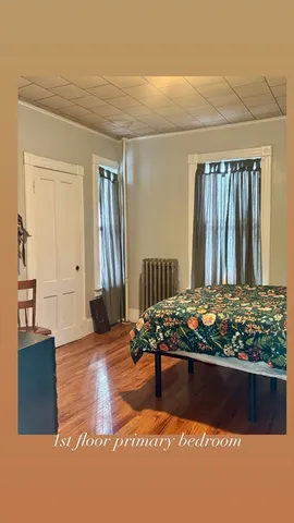 a view of a room with wooden floor and furniture