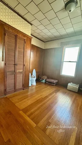 a view of a room with wooden floor and chair