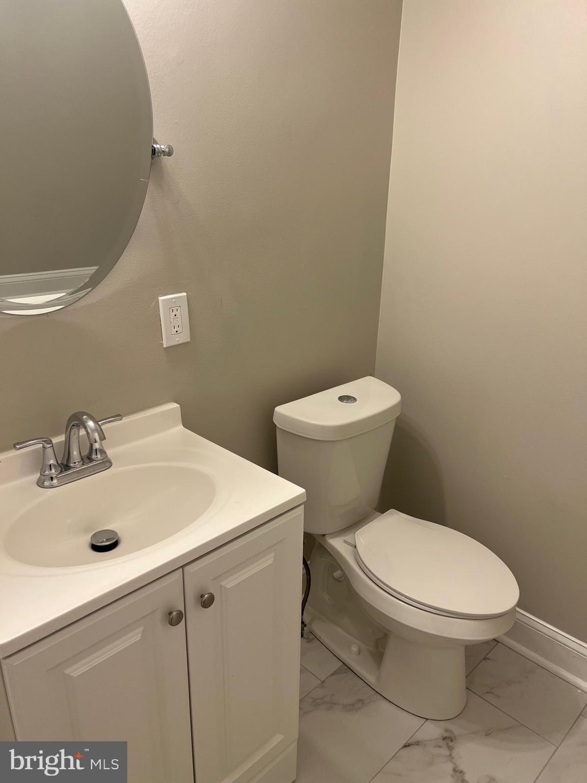 820 North Rose Street Baltimore, MD 21205 - Photo 16 of 20 a white toilet sitting next to a bathroom sink