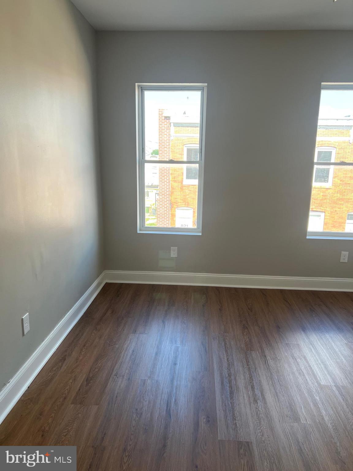 820 North Rose Street Baltimore, MD 21205 - Photo 17 of 20 an empty room with wooden floor and windows