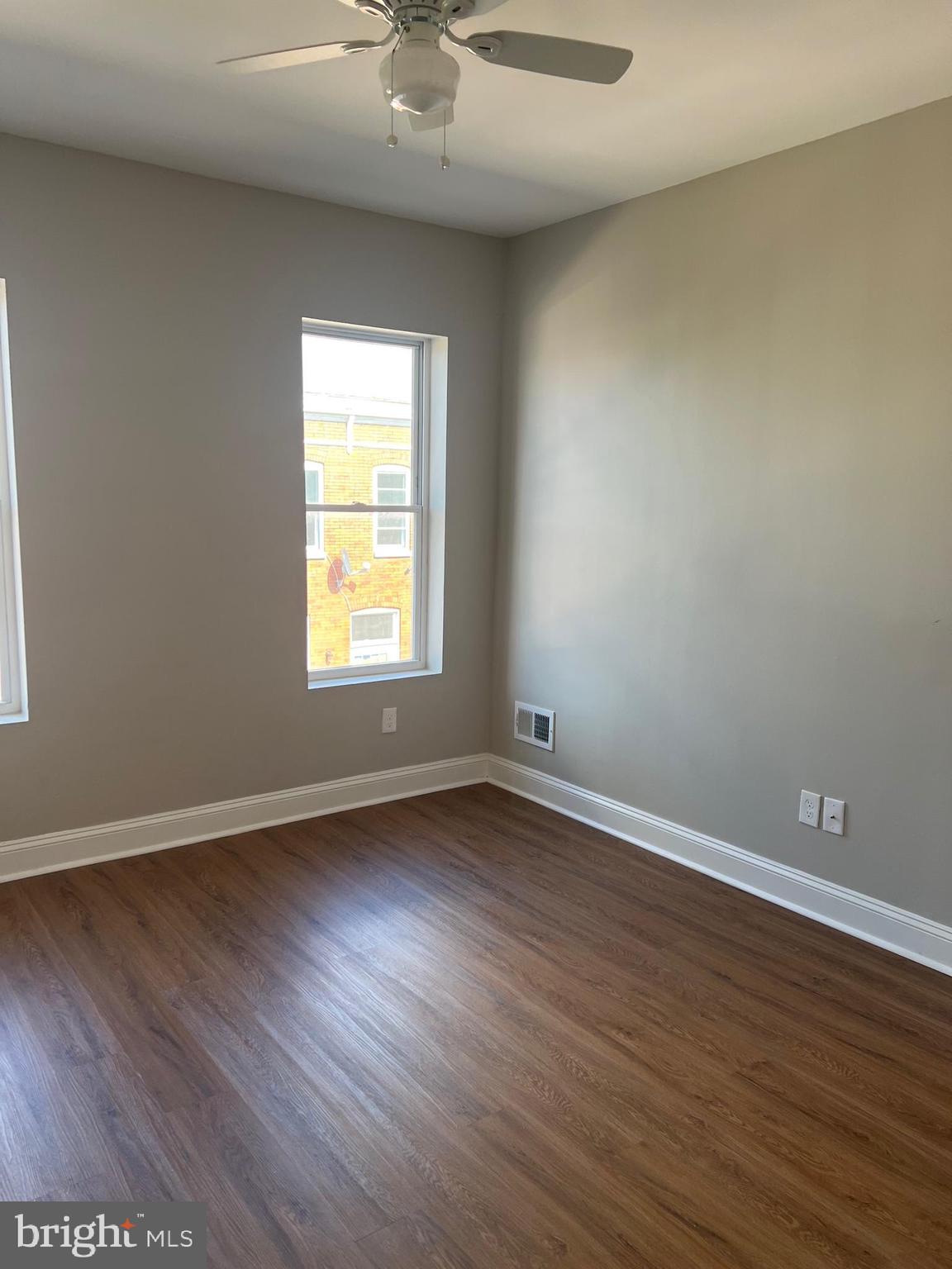 820 North Rose Street Baltimore, MD 21205 - Photo 18 of 20 a view of an empty room with wooden floor and a window
