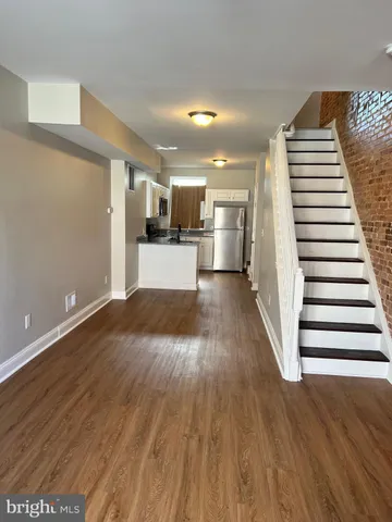 a view of a room with wooden floor