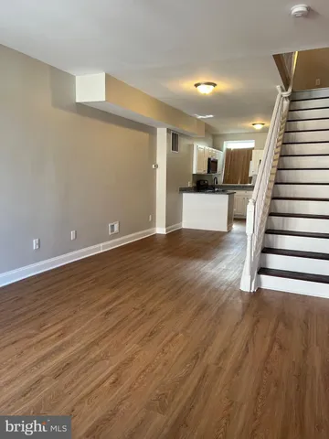 a kitchen with granite countertop a sink a microwave and cabinets