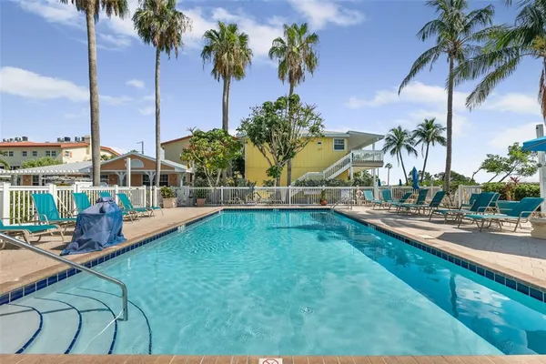 a kitchen with a sink dishwasher and white cabinets with wooden floor