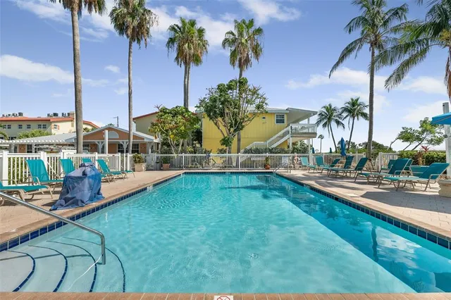 a kitchen with a sink dishwasher and white cabinets with wooden floor