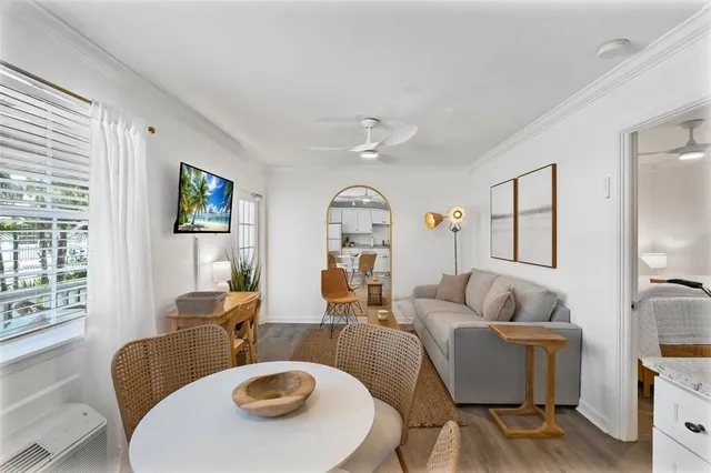 a living room with stainless steel appliances kitchen island granite countertop furniture and a dining table