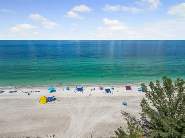 a living room with furniture a rug and a table