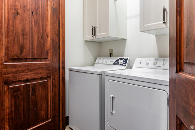 5326 North Oldgate Road Heber City, UT 84032 - Photo 14 of 32 Laundry area featuring white cabinetry with dark hardware and paneled wood doors