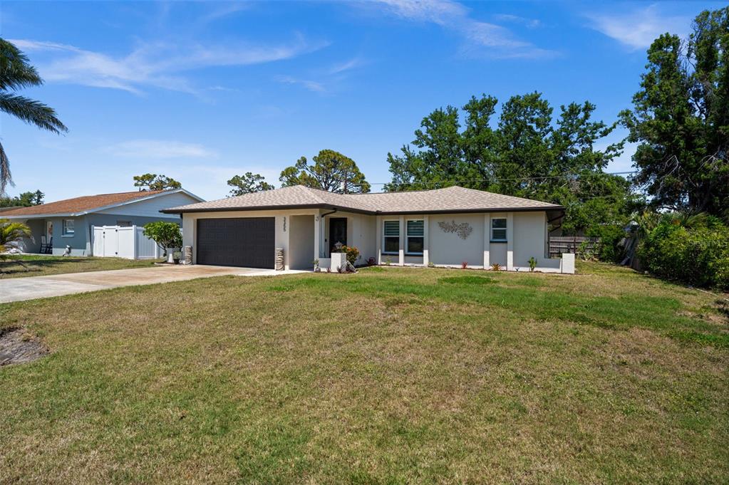 3355 Roslyn Road Venice, FL 34293 - Photo 1 of 1 a front view of a house with a garden