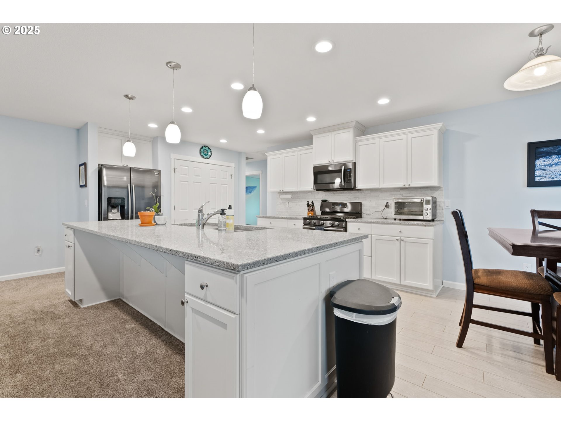 10360 Skyview Road Tillamook, OR 97141 - Photo 13 of 47 a kitchen with kitchen island a sink table and chairs
