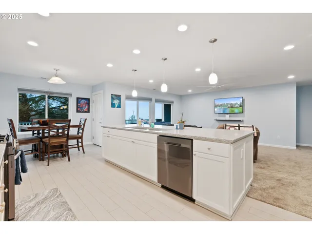 a kitchen with kitchen island sink and white appliances