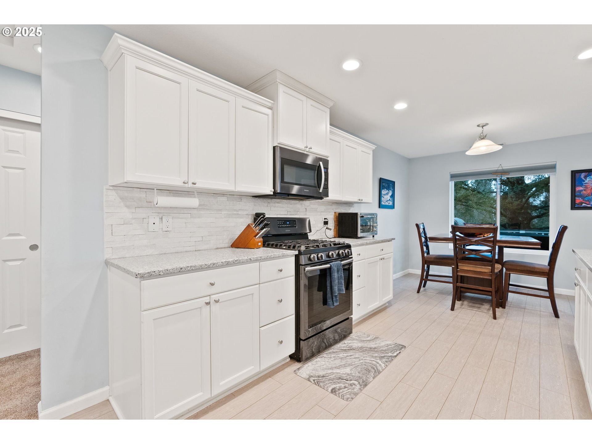 10360 Skyview Road Tillamook, OR 97141 - Photo 17 of 47 a kitchen with stainless steel appliances kitchen island granite countertop a stove a sink and a microwave