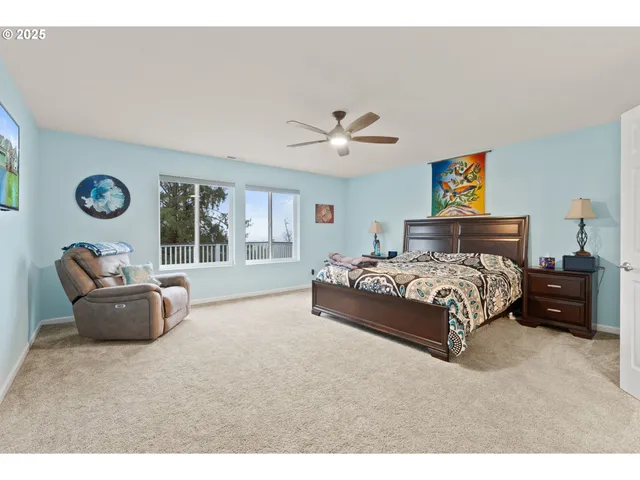 a bedroom with a bed and a large window