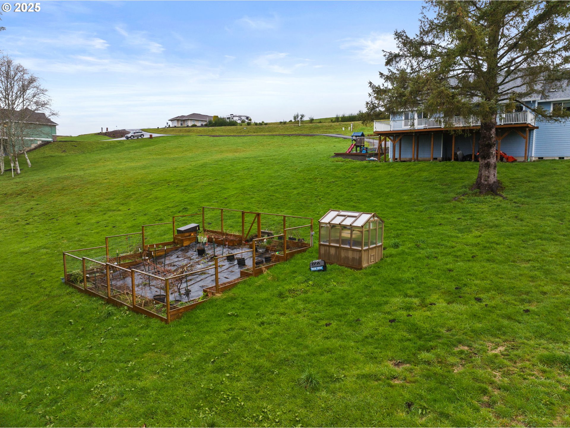 10360 Skyview Road Tillamook, OR 97141 - Photo 39 of 47 a view of a garden with lawn chairs and a large tree