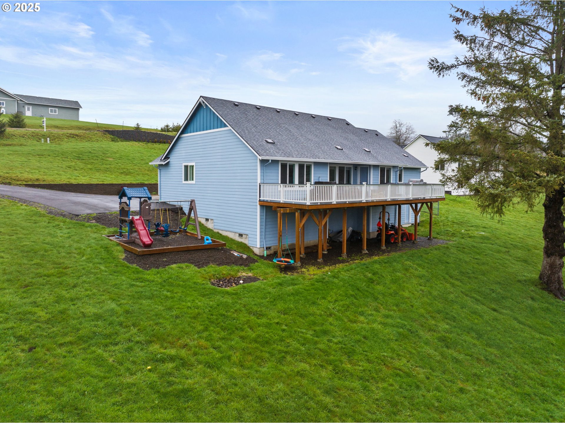 10360 Skyview Road Tillamook, OR 97141 - Photo 40 of 47 a view of a house with a big yard and large tree