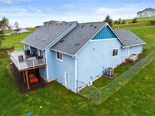 an aerial view of residential house with green yard