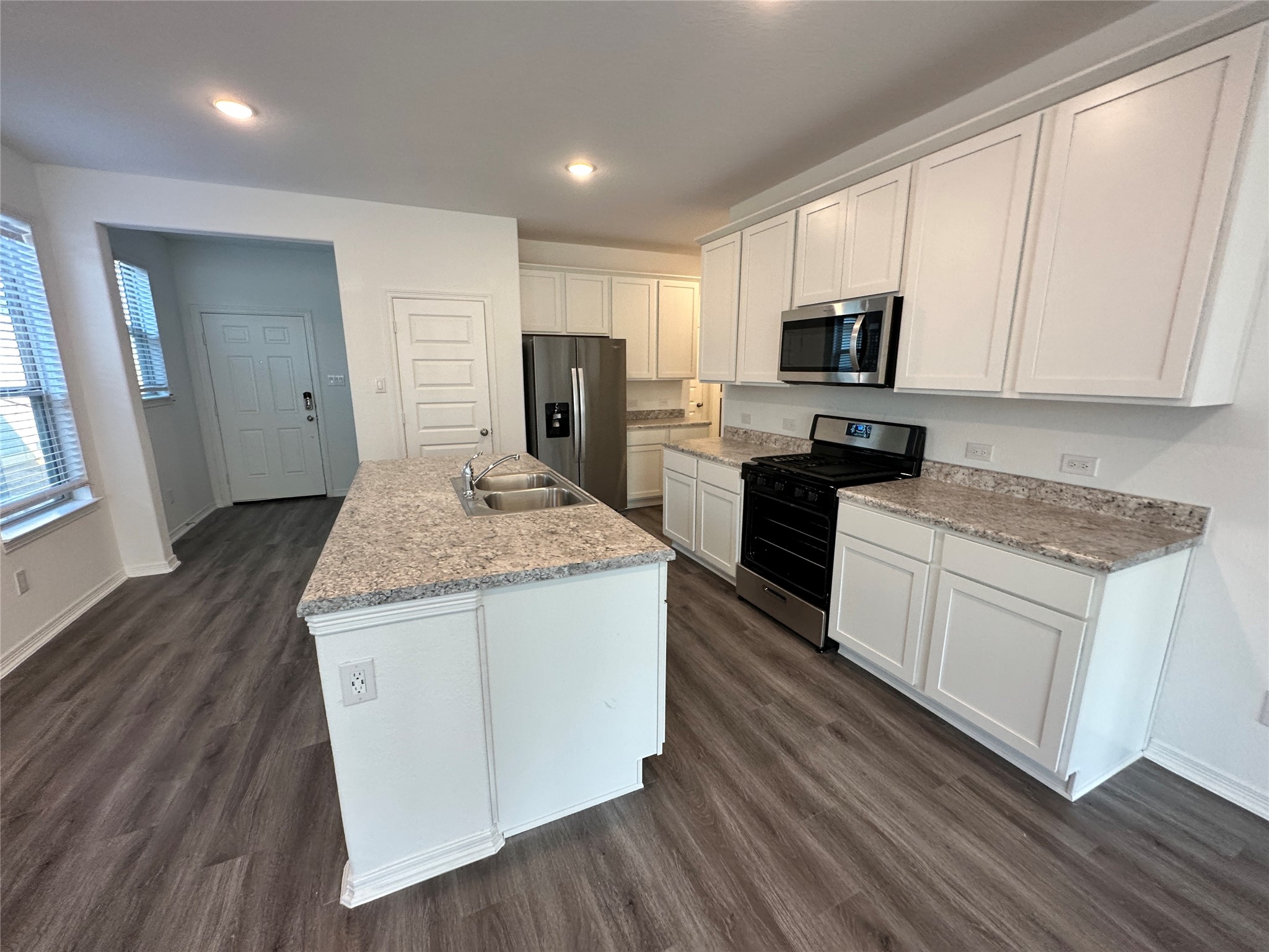 16622 Moss Lane Porter, TX 77365 - Photo 4 of 18 a kitchen with granite countertop a sink stove and refrigerator