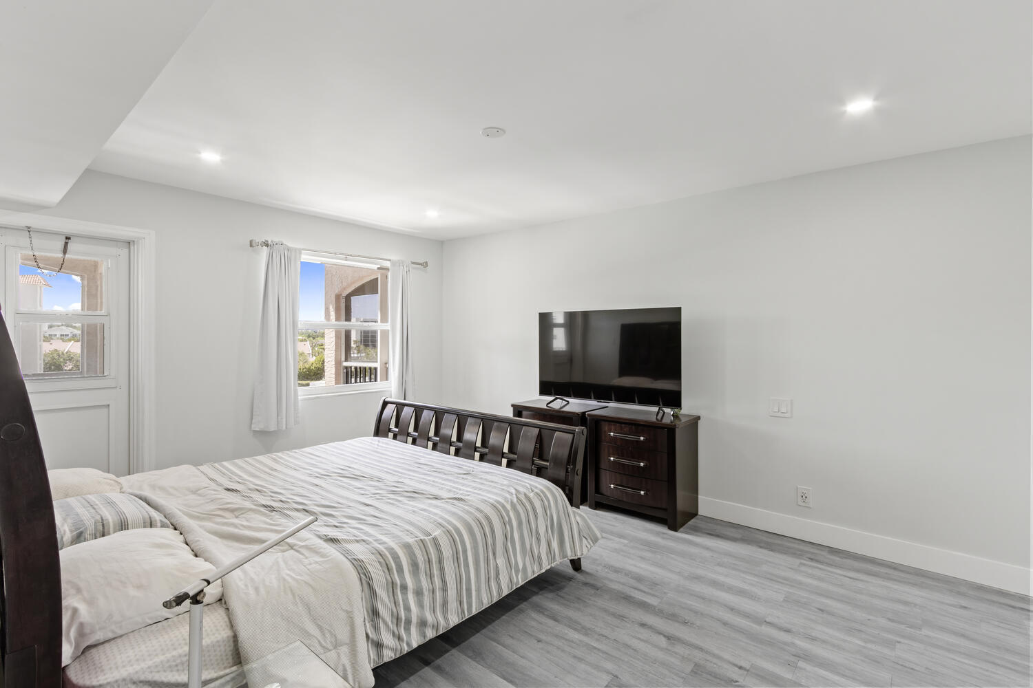2871 North Ocean Boulevard, Unit V443 Boca Raton, FL 33431 - Photo 19 of 49 a bedroom with a bed and a flat screen tv