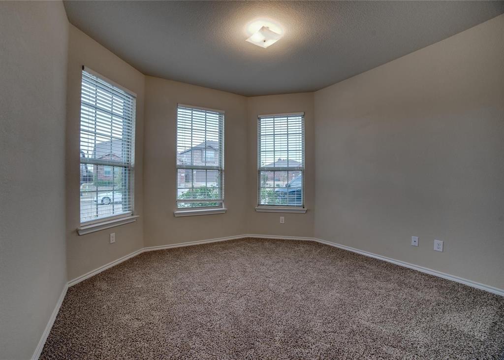 2408 Windhaven Drive Denton, TX 76210 - Photo 11 of 13 an empty room with windows