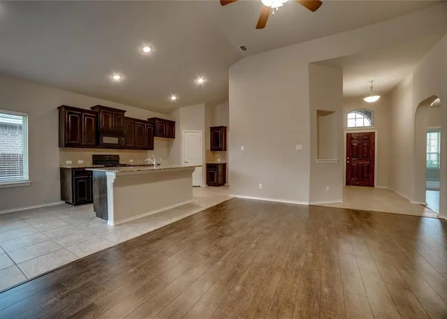 a large kitchen with kitchen island a sink stainless steel appliances and cabinets