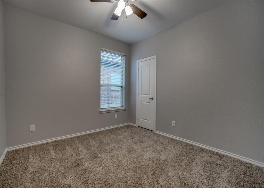 2408 Windhaven Drive Denton, TX 76210 - Photo 10 of 13 an empty room with windows and fan