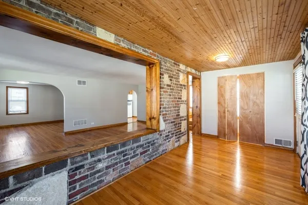 a view of a room with wooden floor