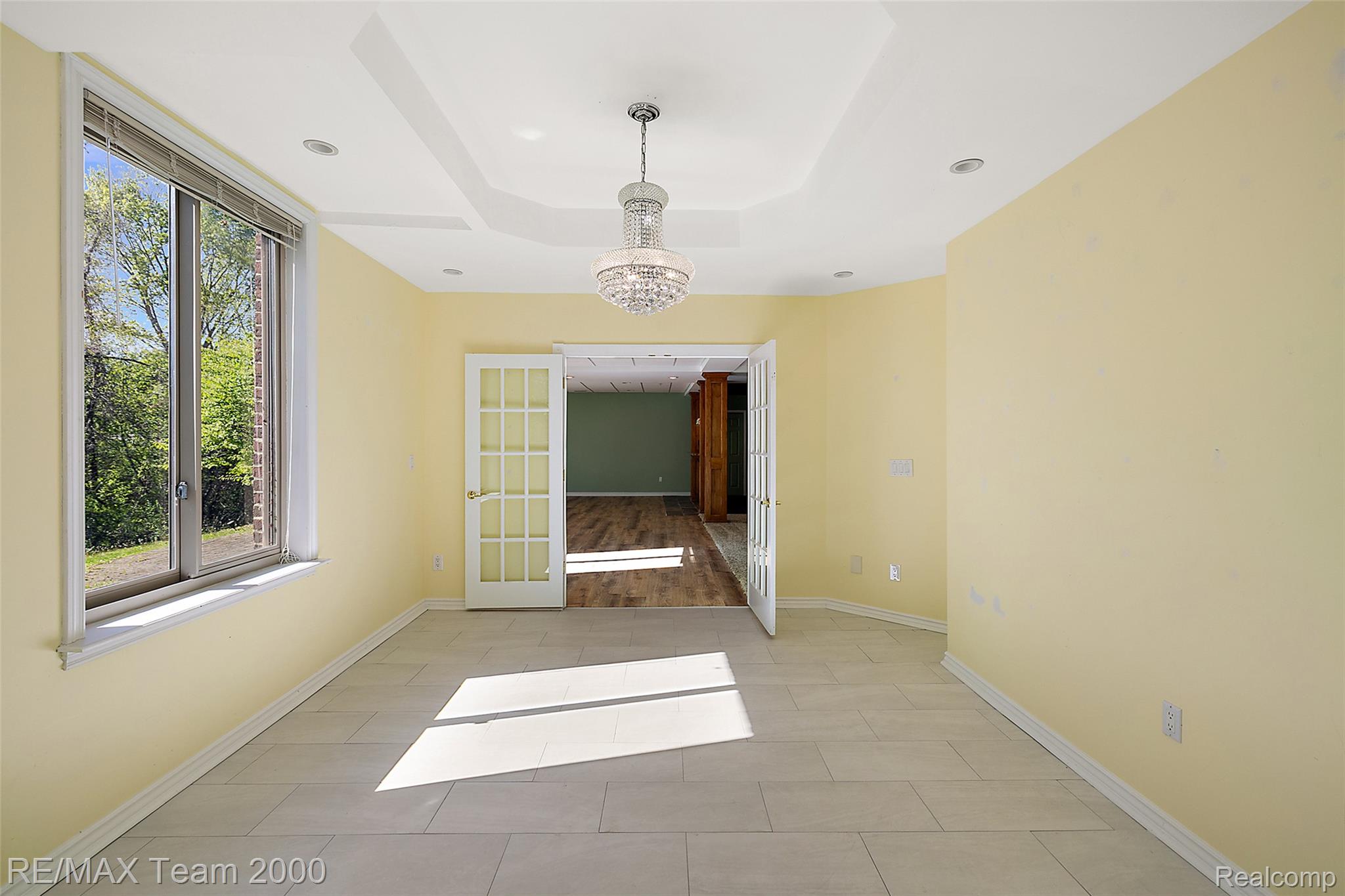 630 Sheldon Court Rochester, MI 48306 - Photo 80 of 94 Unfurnished room with french doors, suspended lighting, and a raised ceiling