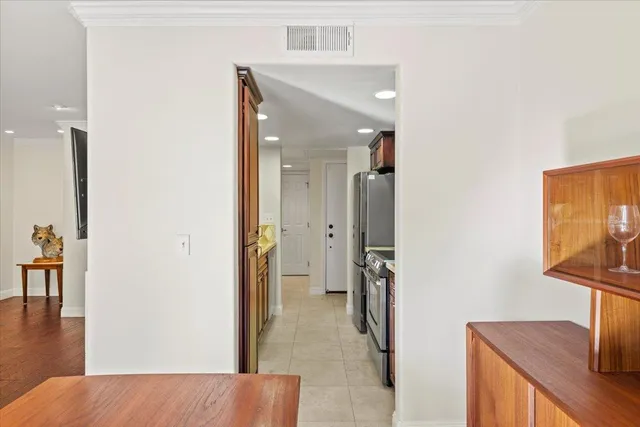 a view of a hallway with wooden floor and furniture