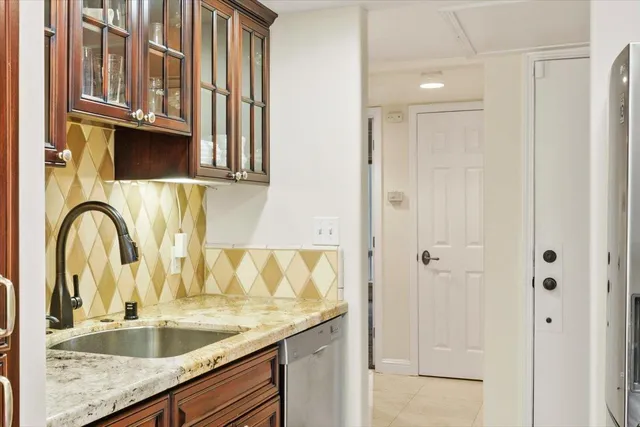 a close view of a sink and a granite countertop