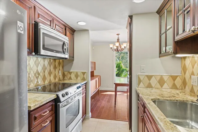 a view of a kitchen cabinets a sink and a wooden floor