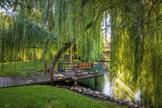 a backyard of a house with table and chairs
