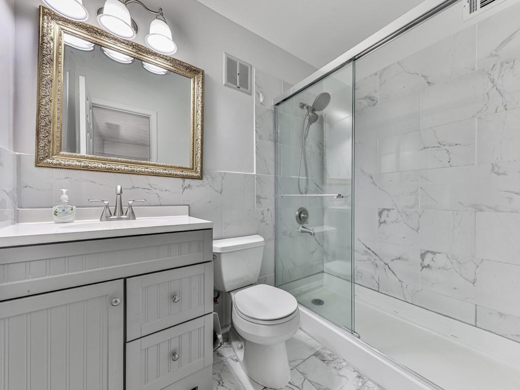 6700 Roswell Road, Unit 24E Atlanta, GA 30328 - Photo 4 of 14 a bathroom with a sink a toilet and shower