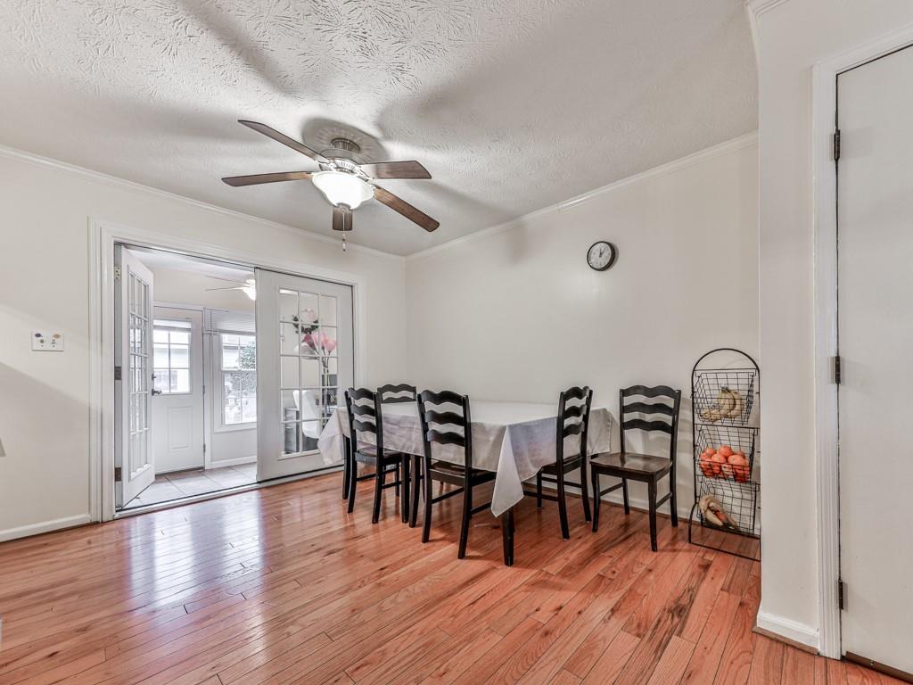 6700 Roswell Road, Unit 24E Atlanta, GA 30328 - Photo 7 of 14 a view of a dining room with furniture and wooden floor