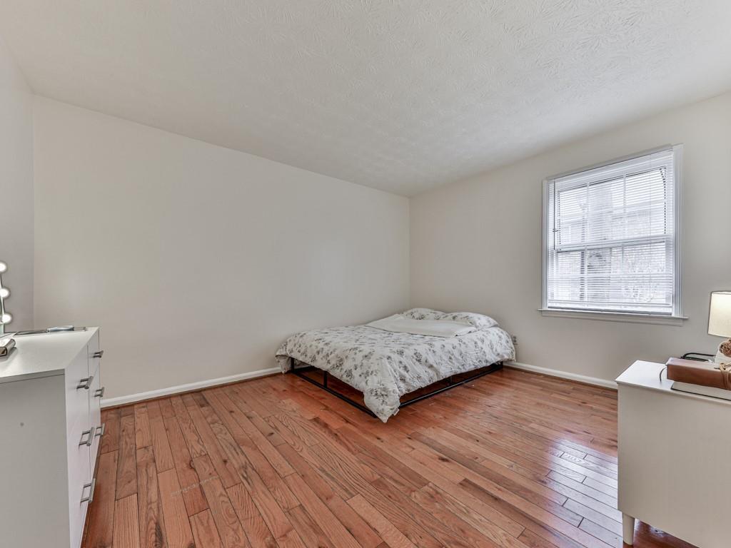 6700 Roswell Road, Unit 24E Atlanta, GA 30328 - Photo 9 of 14 a bedroom with a bed and a window