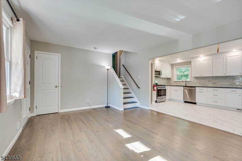 15 Woodmere Street Raritan, NJ 08869 - Photo 5 of 16 a view of a kitchen with wooden floor and stairs