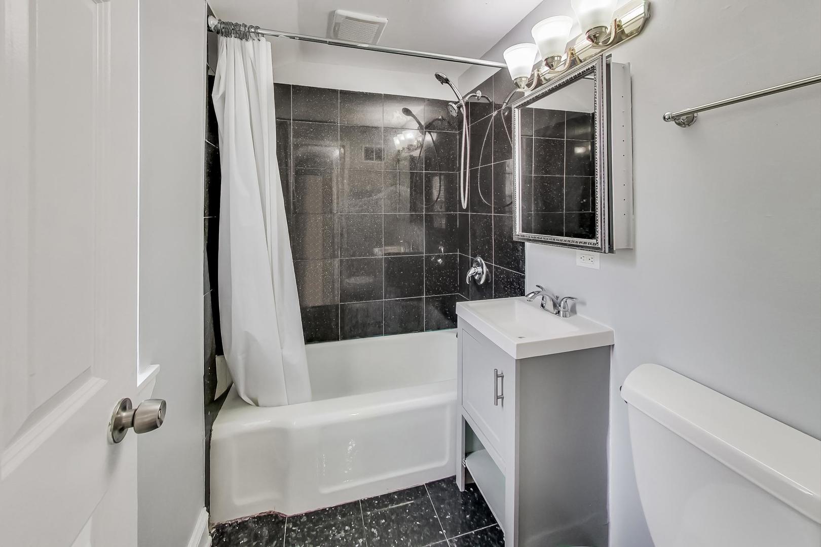 402 North Main Street Mount Prospect, IL 60056 - Photo 13 of 19 a bathroom with a shower toilet and sink