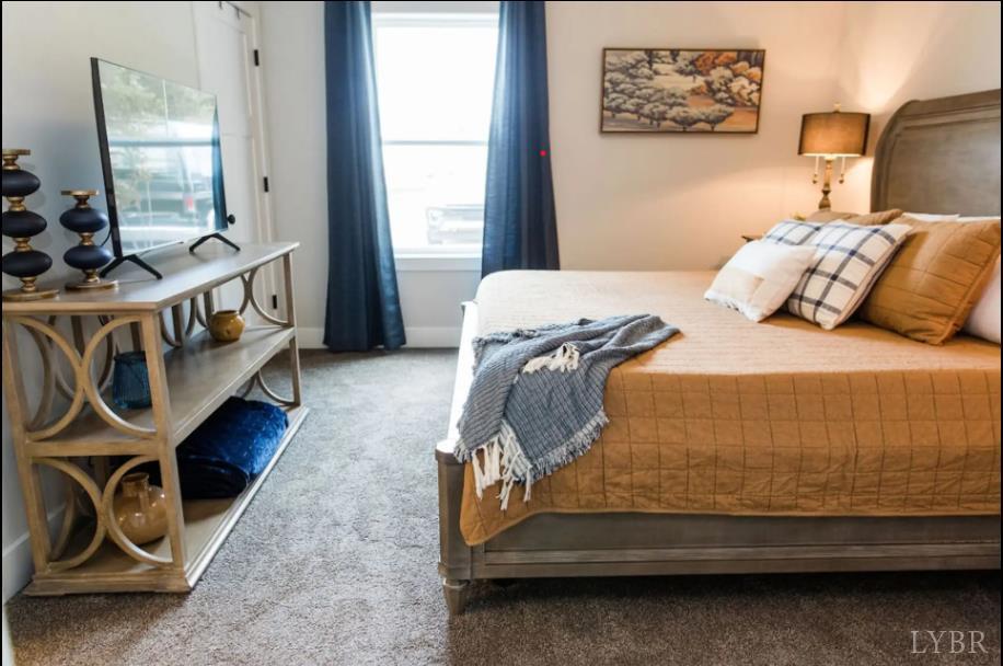 1300 Stoney Ridge Boulevard, Unit 101 Forest, VA 24551 - Photo 7 of 18 a bedroom with bed and a window