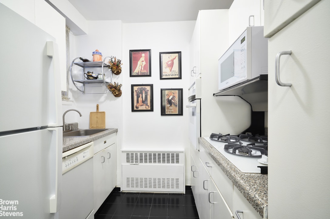 123 East 75th Street, Unit 6A Manhattan, NY 10021 - Photo 2 of 5 a kitchen with stainless steel appliances a cabinets and a counter top space