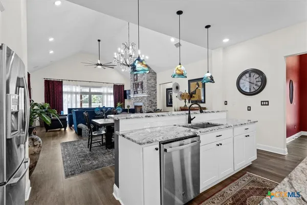 a large kitchen with a table and chairs