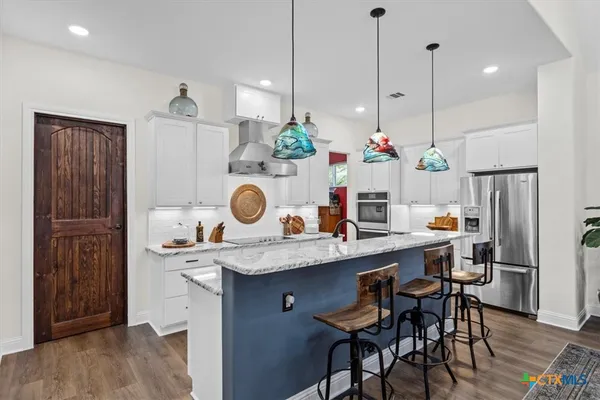 a view of a kitchen with a table and chairs