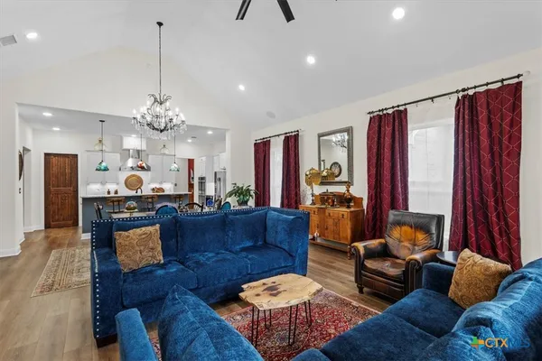 a living room with furniture and a chandelier