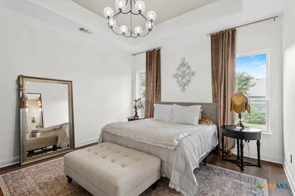 a bedroom with a bed and a mirror