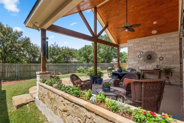 a view of sitting area in backyard and chair