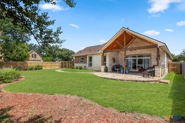 a front view of a house with garden and lake view