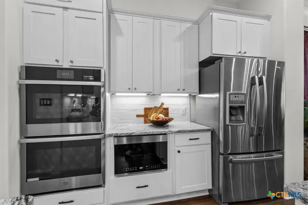 a kitchen with appliances and cabinets