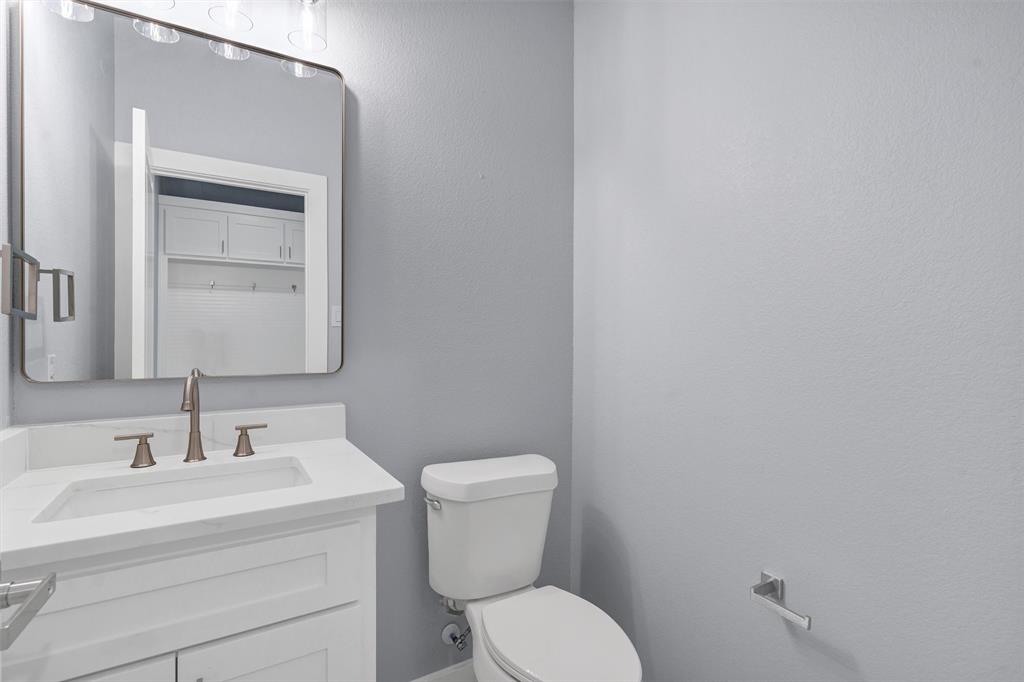 588 Highview Court Godley, TX 76044 - Photo 16 of 38 a bathroom with a toilet a sink and mirror